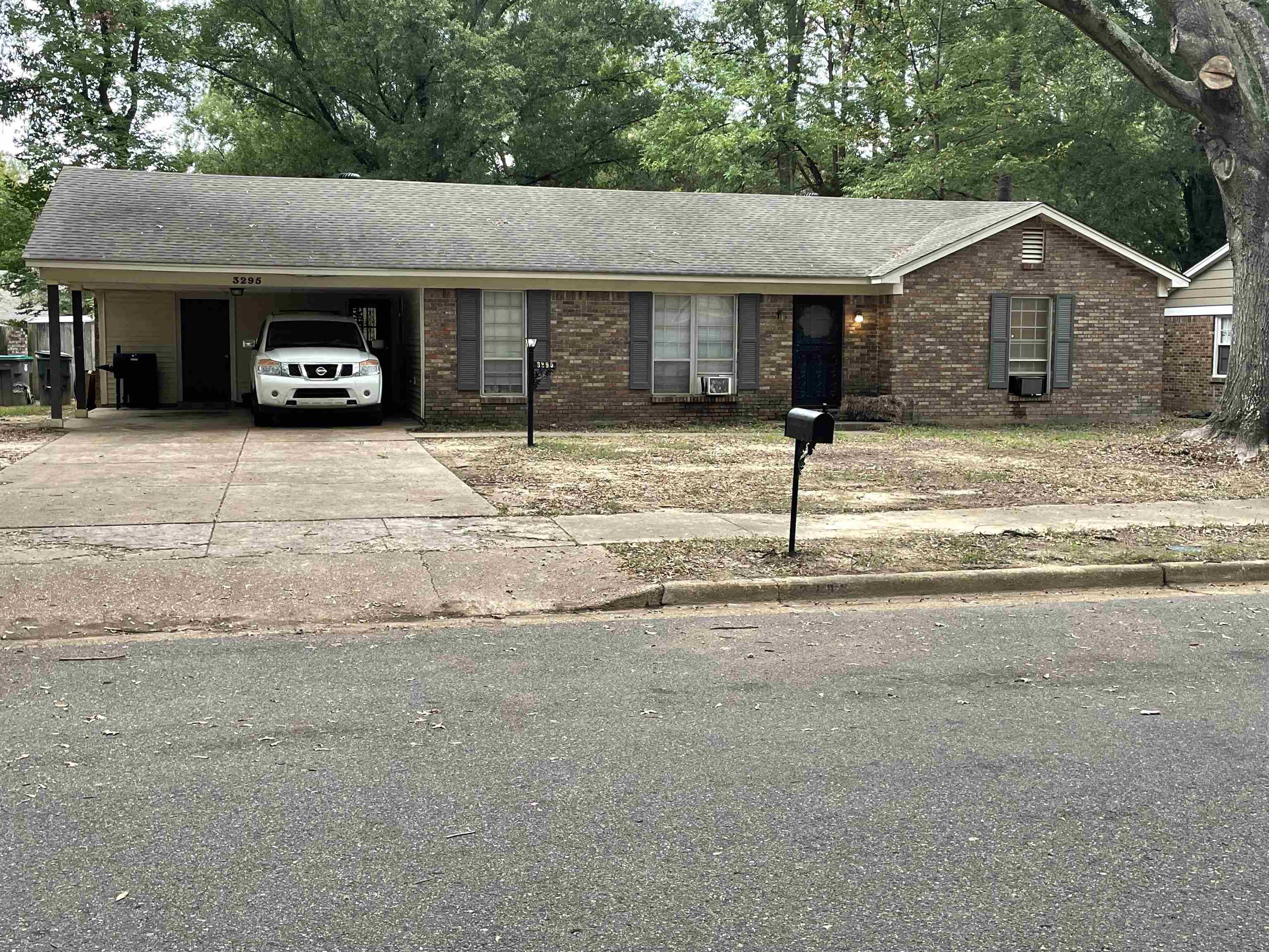 Ranch-style house featuring a carport