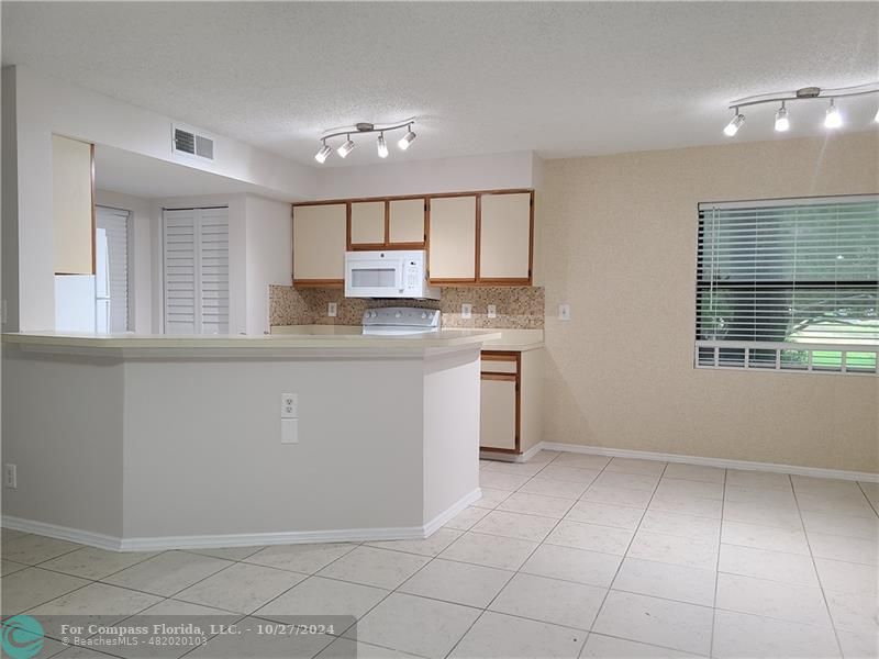 a kitchen with stainless steel appliances a sink a stove a refrigerator and cabinets