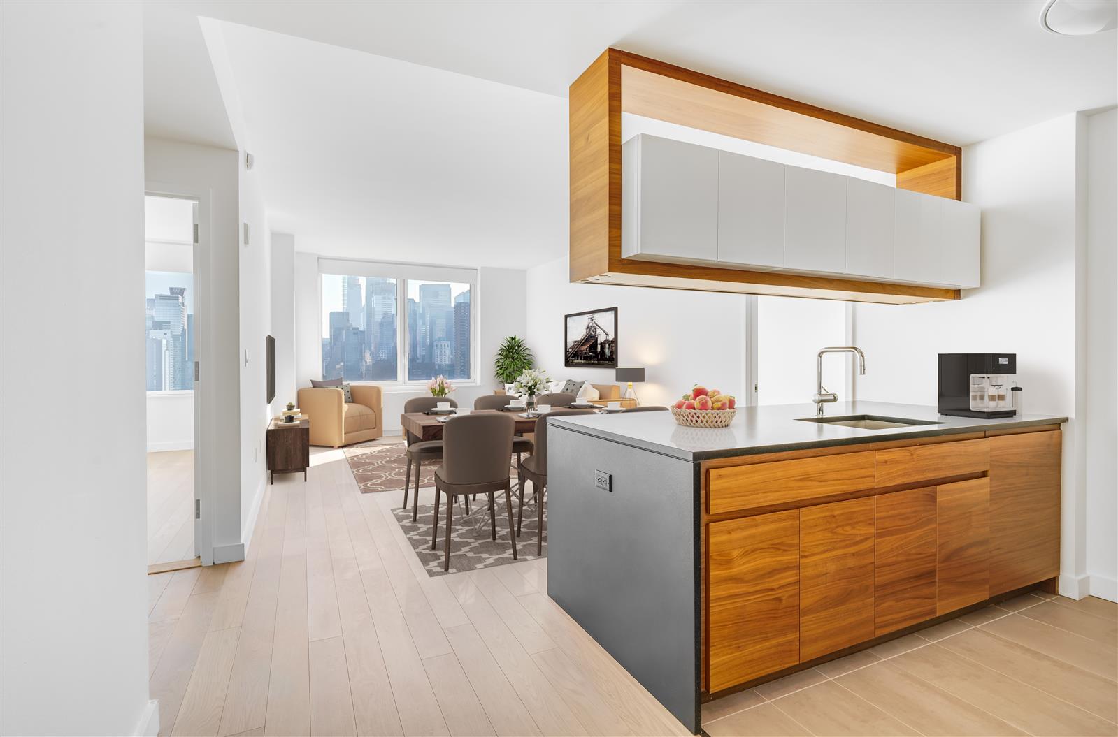 a living room with stainless steel appliances kitchen island granite countertop a sink and cabinets