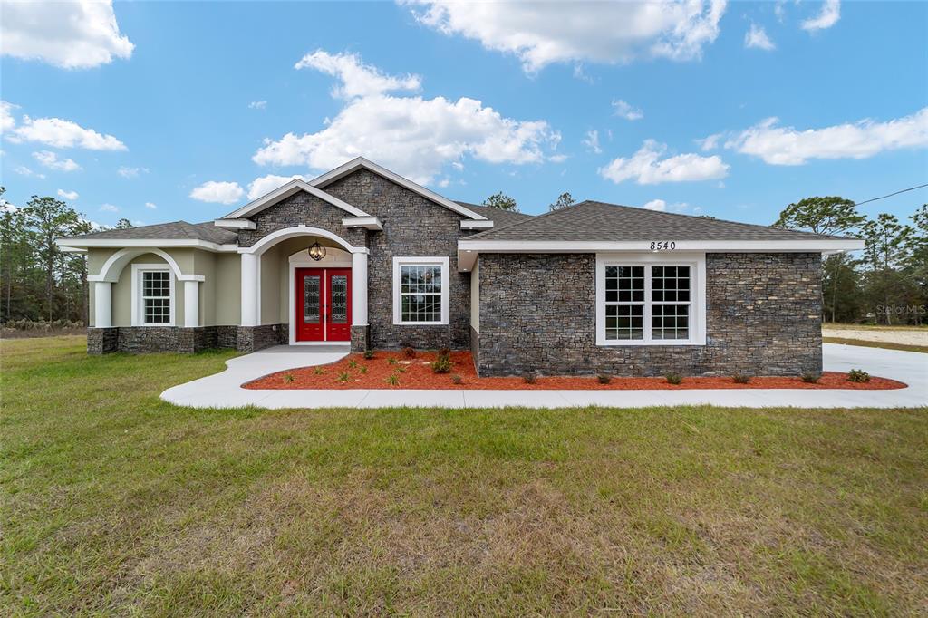 a front view of a house with a yard