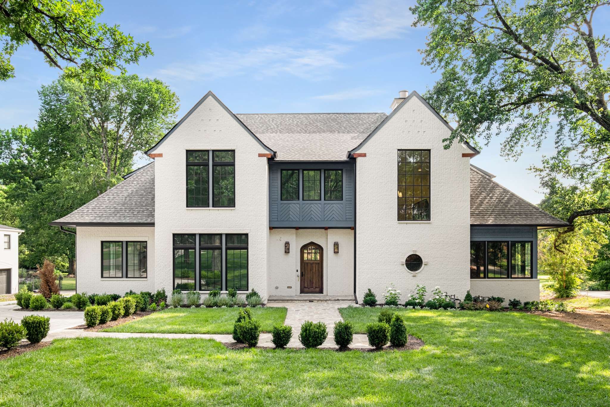 a front view of house with yard and green space