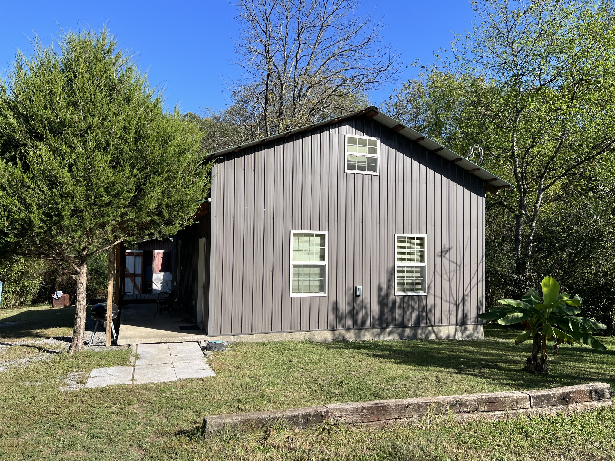 a view of a house with a yard and tree s