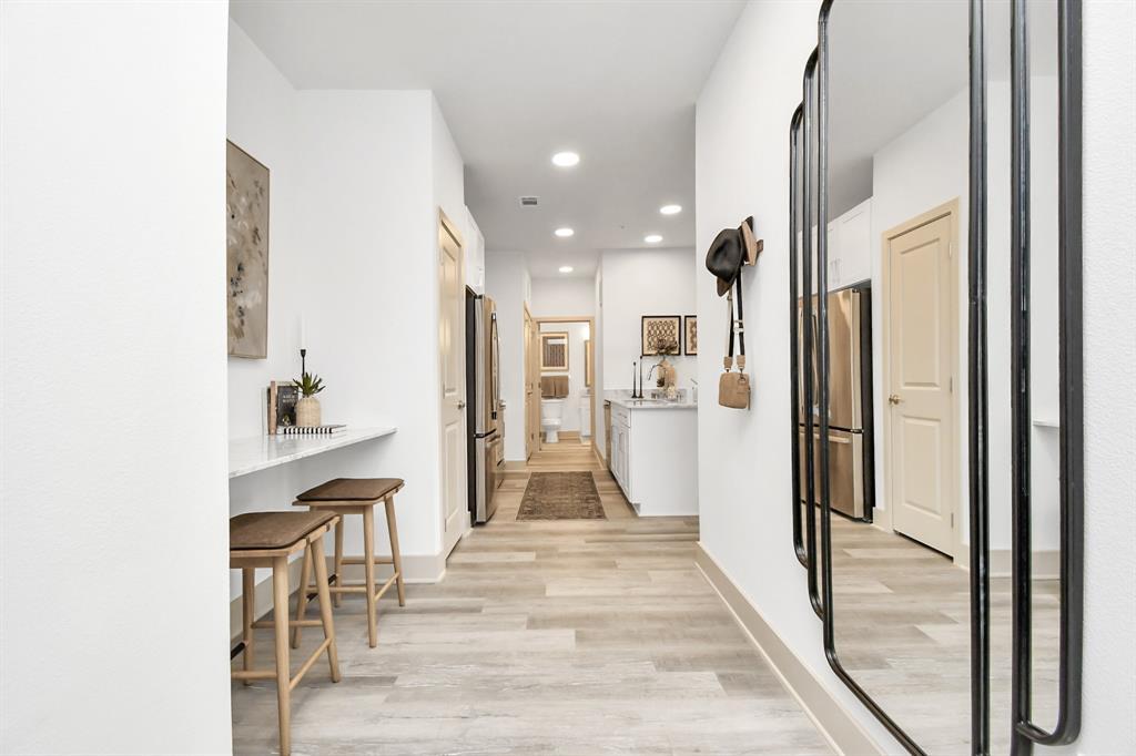 a view of a living room with a sink and cabinets