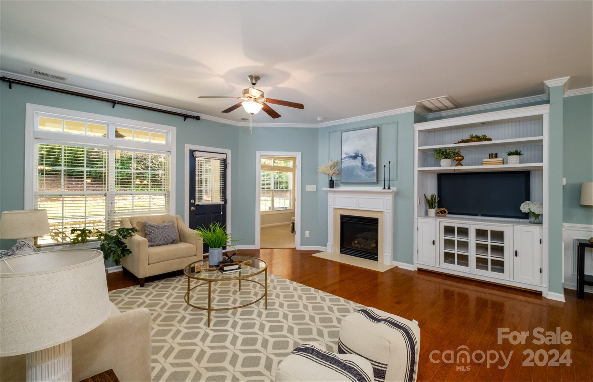 a living room with furniture fireplace and flat screen tv