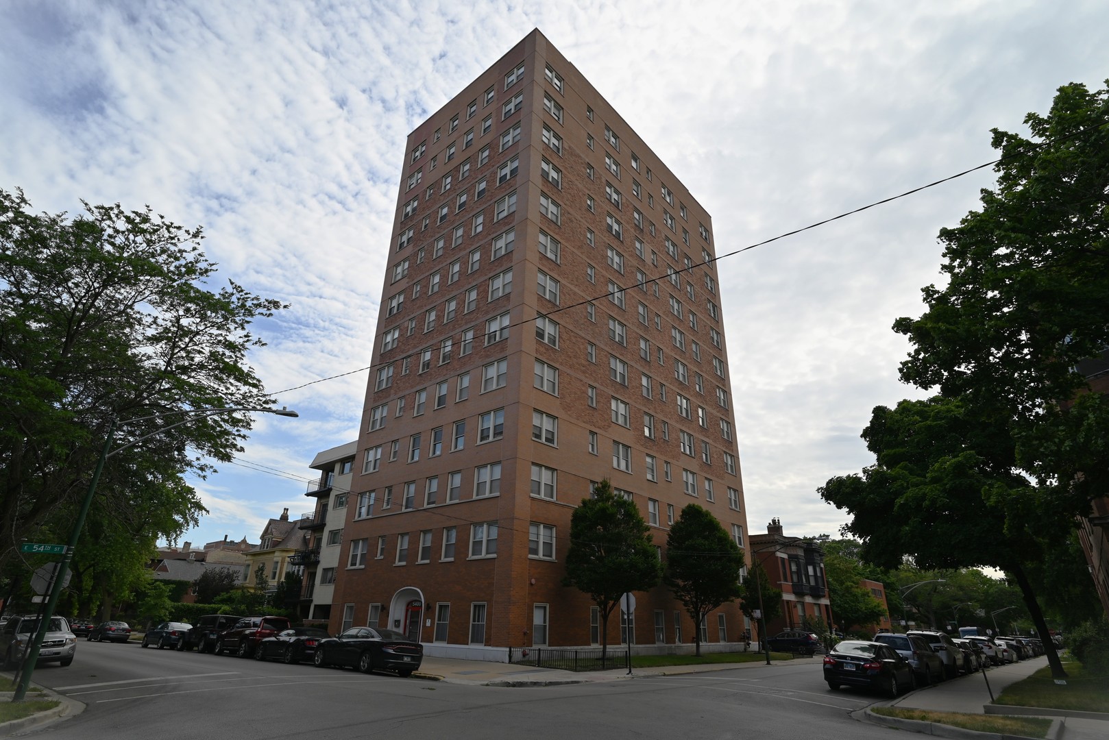 a view of a tall building next to a road