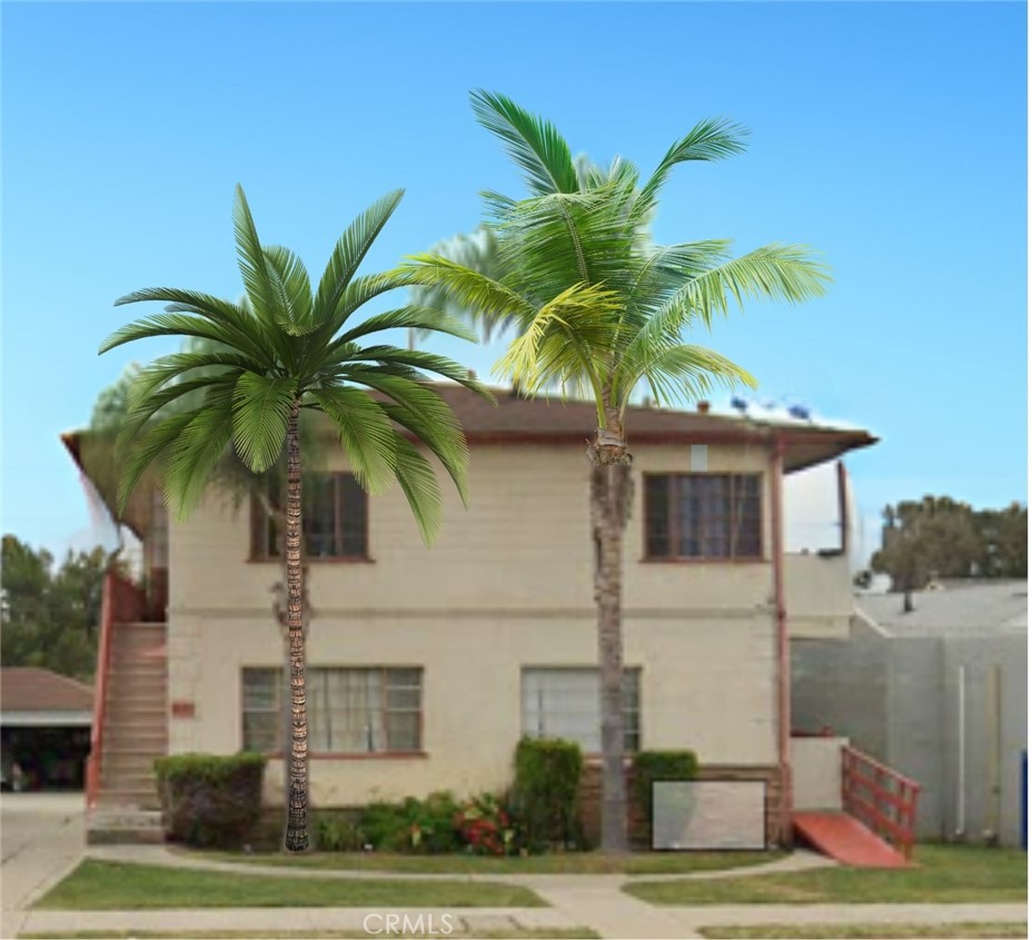 a palm tree sitting in front of a white house