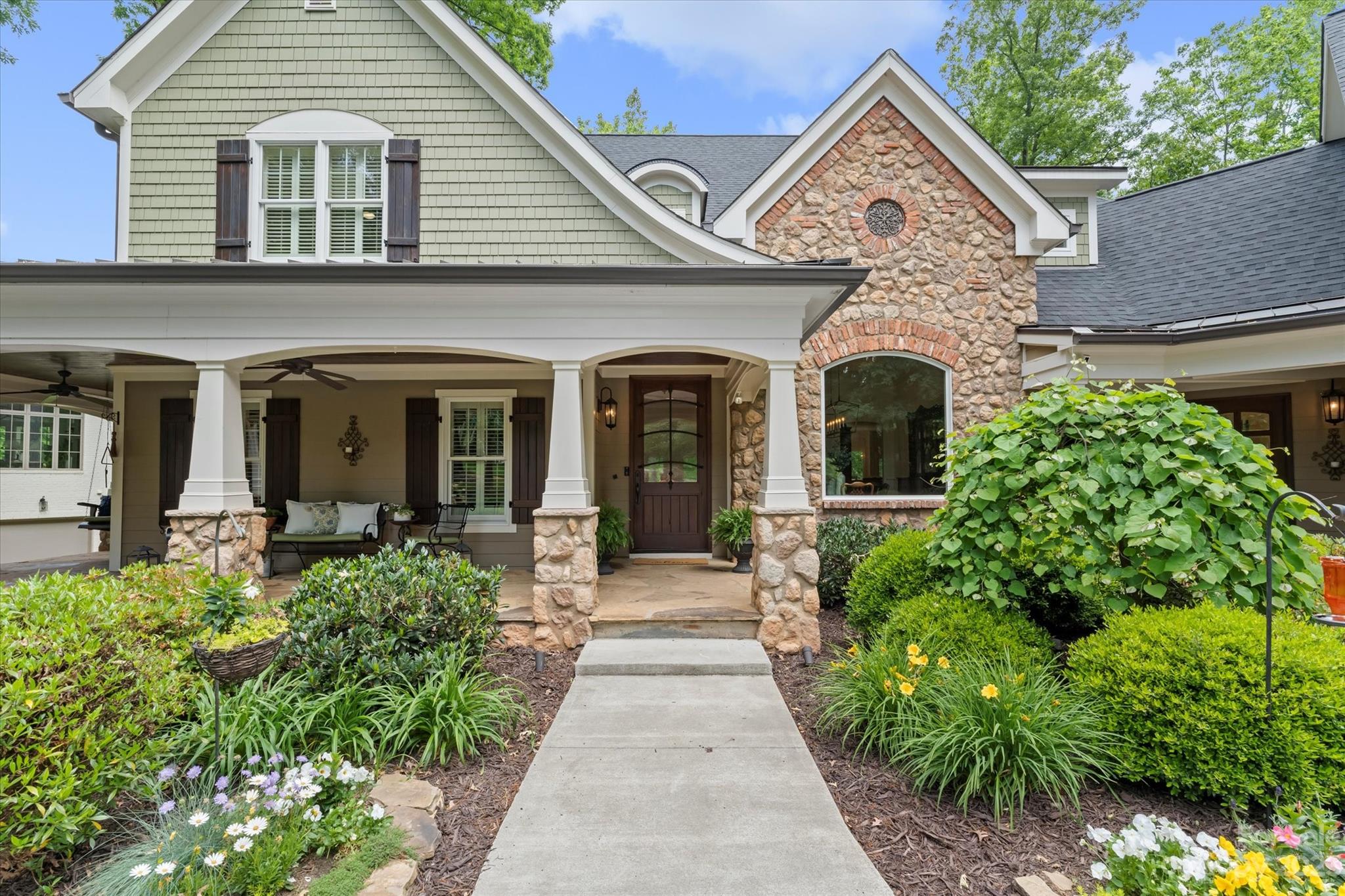 a front view of a house with a garden