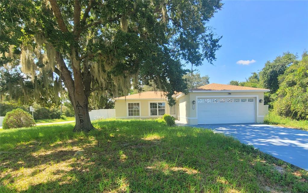 a front view of a house with a garden and yard