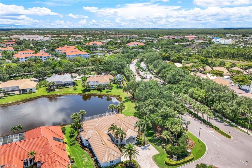 an aerial view of residential houses with outdoor space and lake view