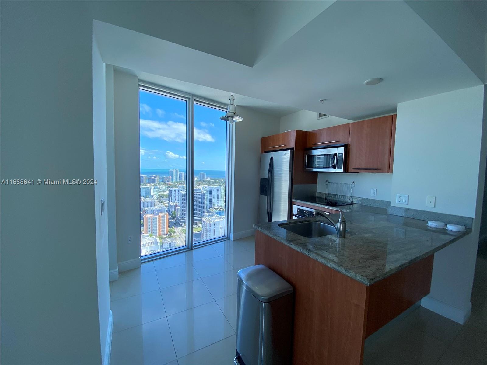 a kitchen with a sink cabinets and wooden floor