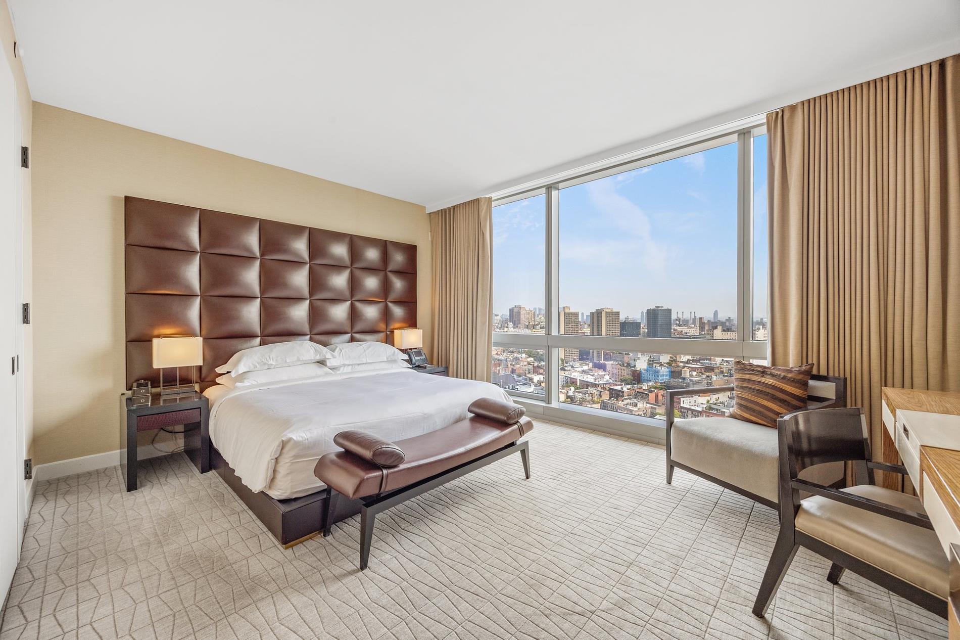 a bedroom with a bed couch and window