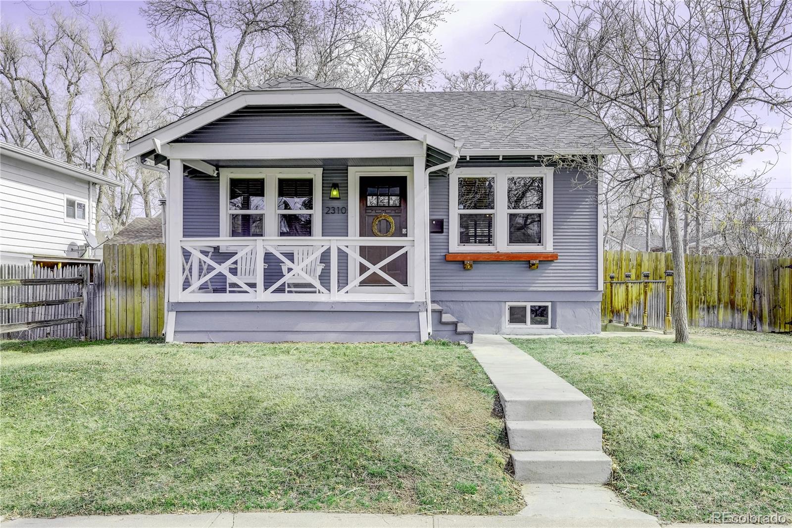 a front view of a house with garden and porch