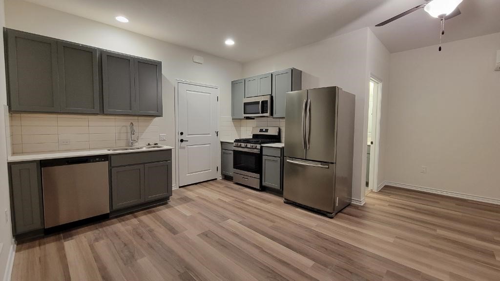 a kitchen with stainless steel appliances granite countertop a refrigerator sink and microwave