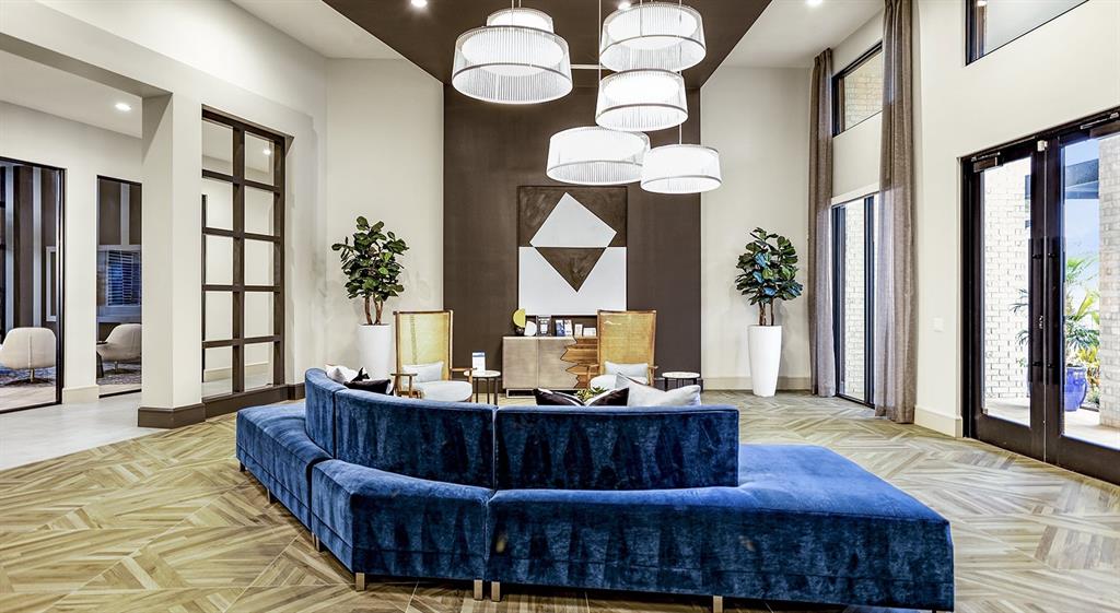 a living room with furniture a chandelier and a wooden floor