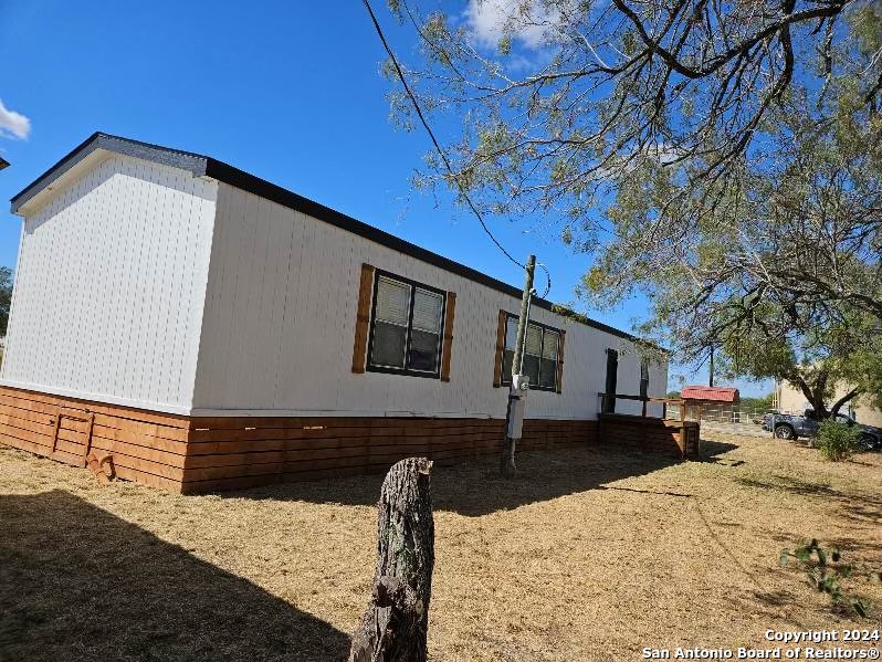 a backyard of a house with wooden fence