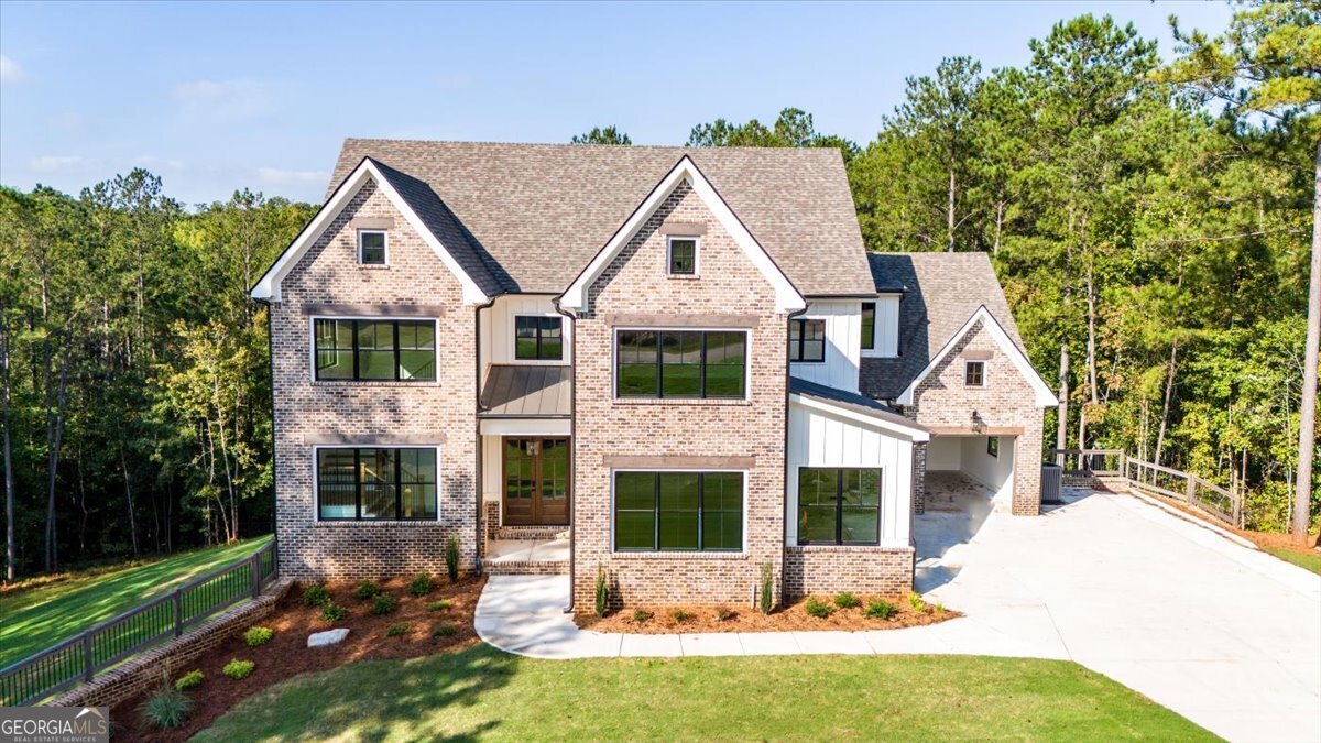 a view of house with yard and outdoor seating