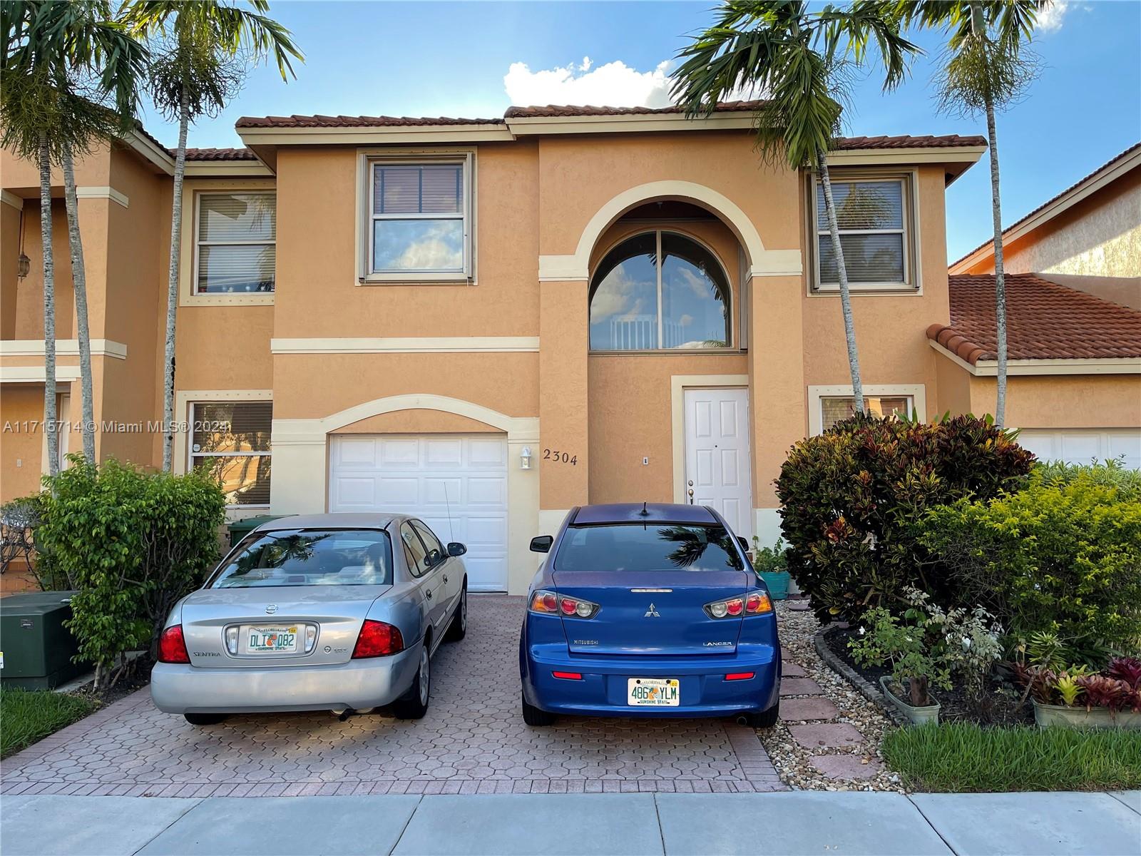 a front view of a house with parking space