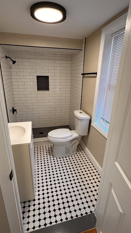 a bathroom with a toilet and a shower