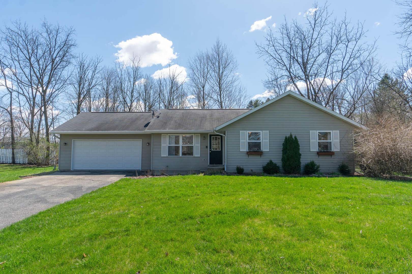 a front view of house with yard and trees