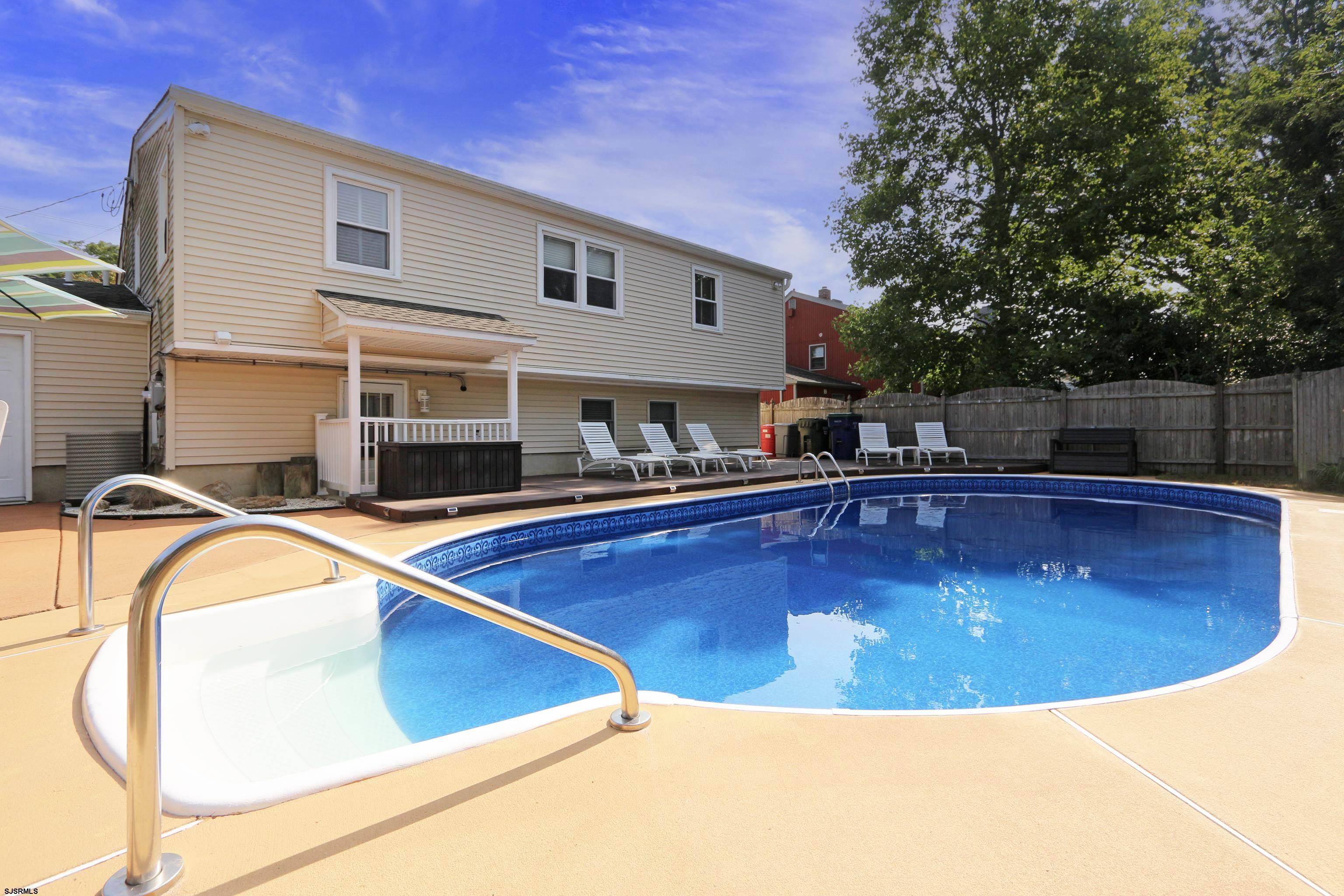 a view of a swimming pool with a lounge chair