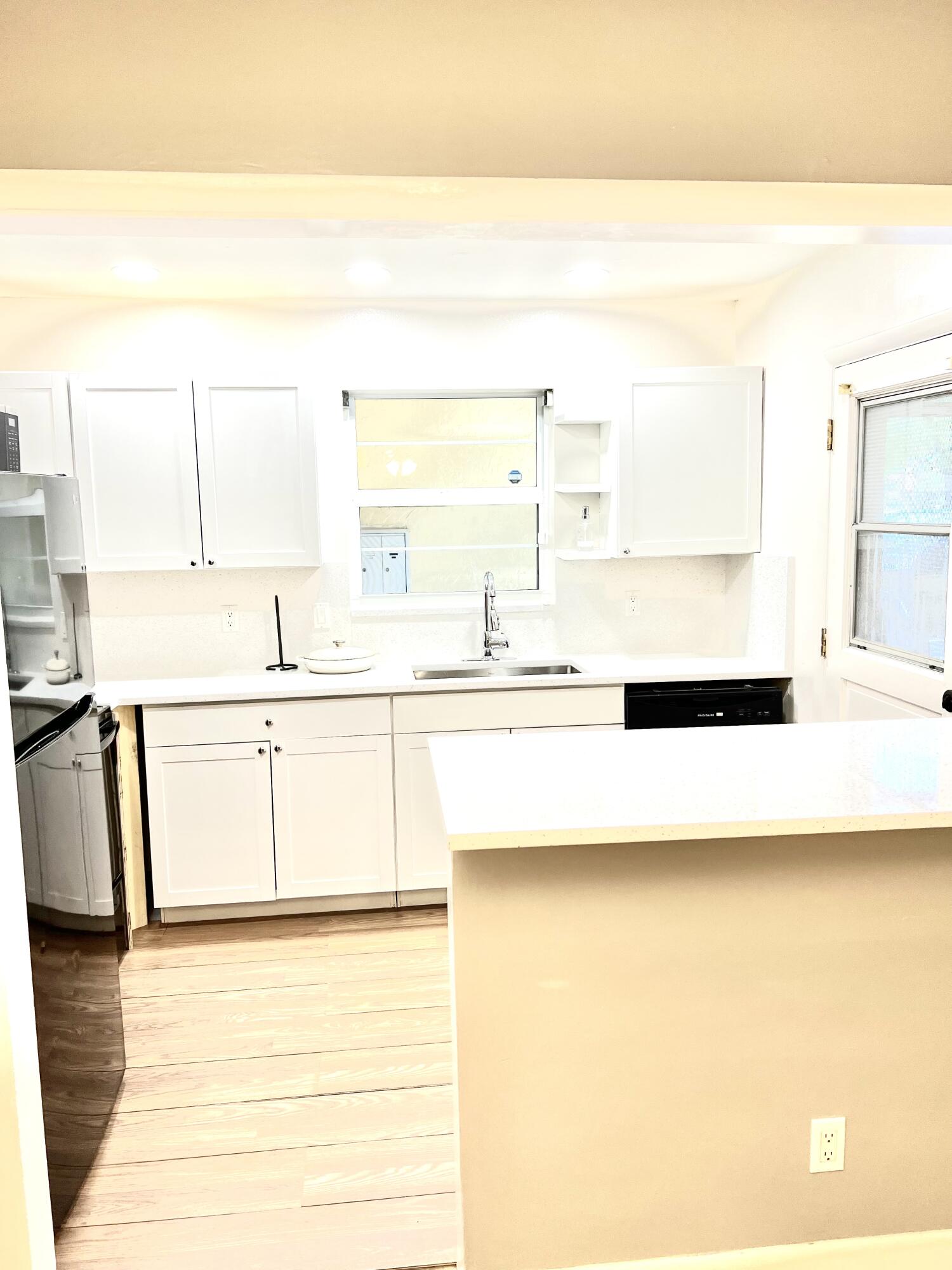 a kitchen with stainless steel appliances granite countertop a sink and a stove