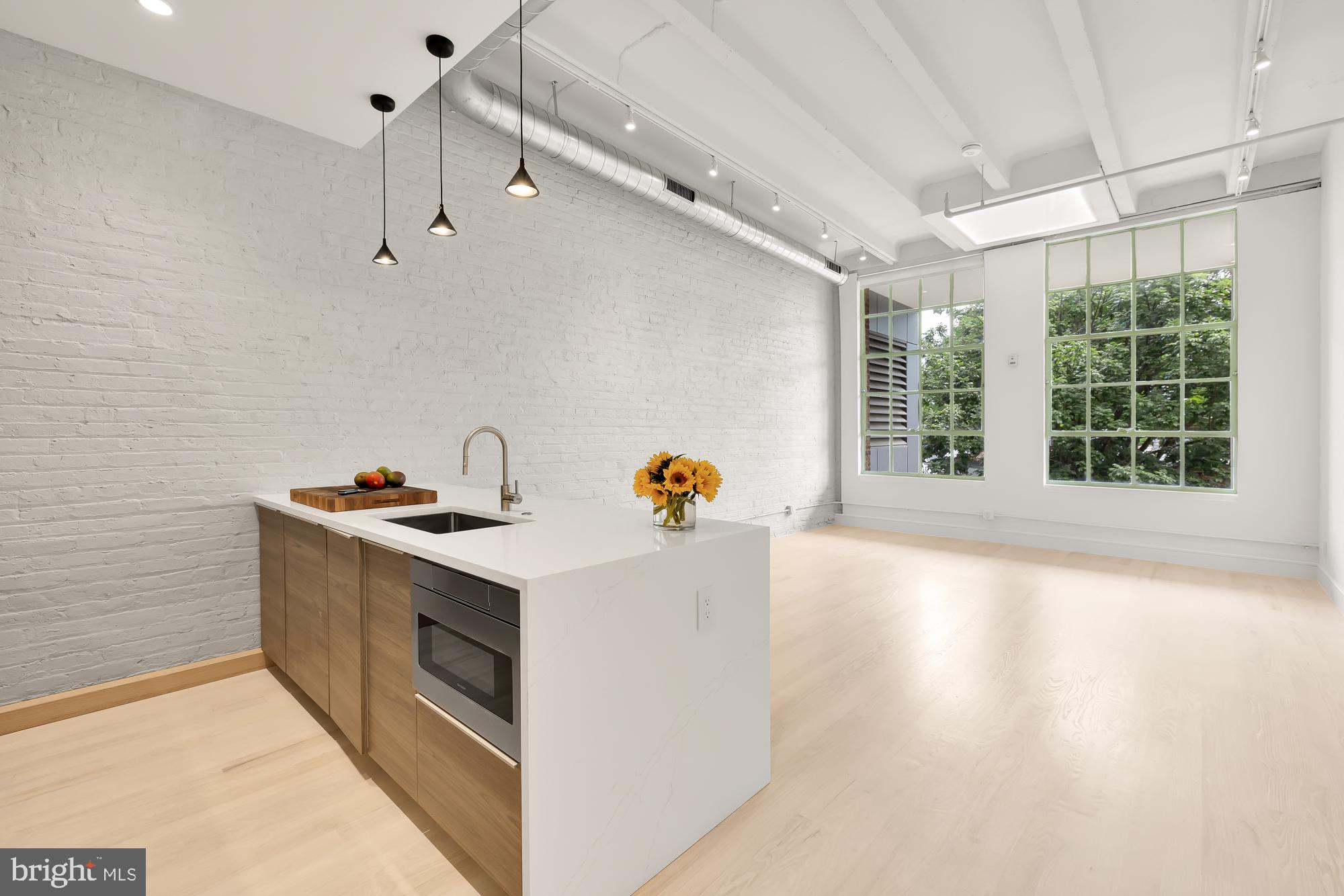 a view of a kitchen with a stove wooden floor and a window