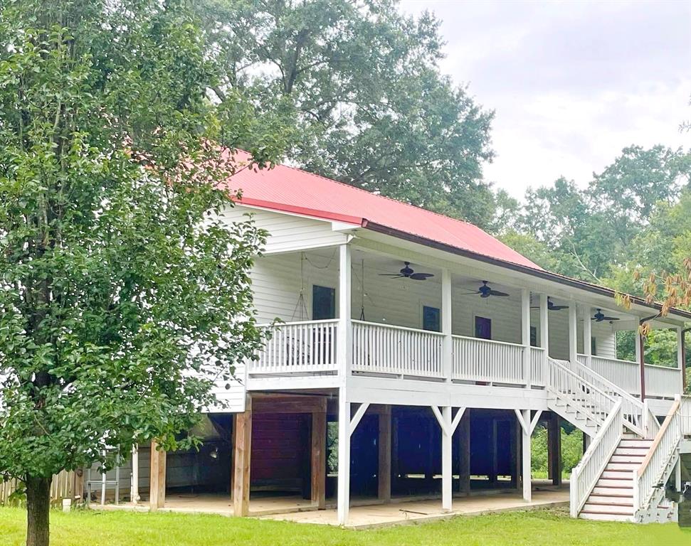 a view of house with a yard