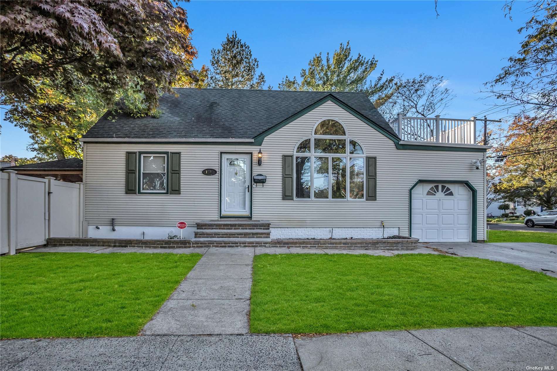 a front view of a house with a garden and yard