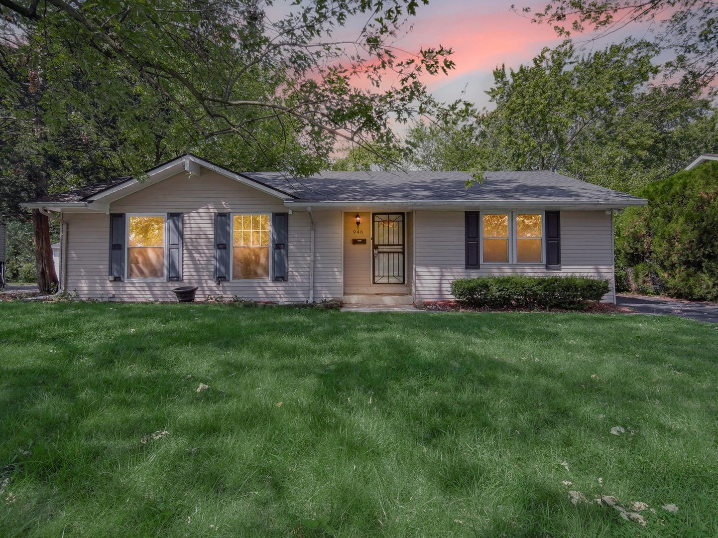 a front view of house with yard and green space