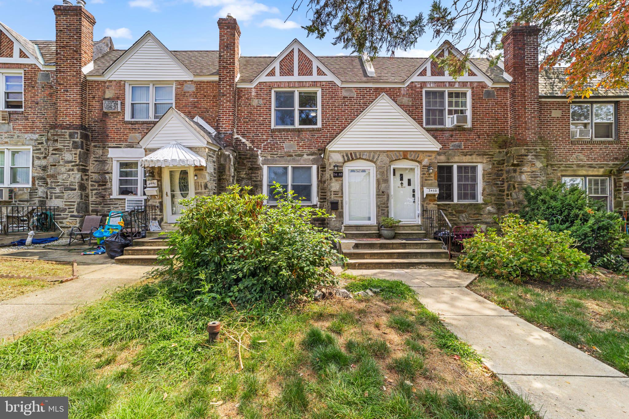 a front view of a house with yard and green space