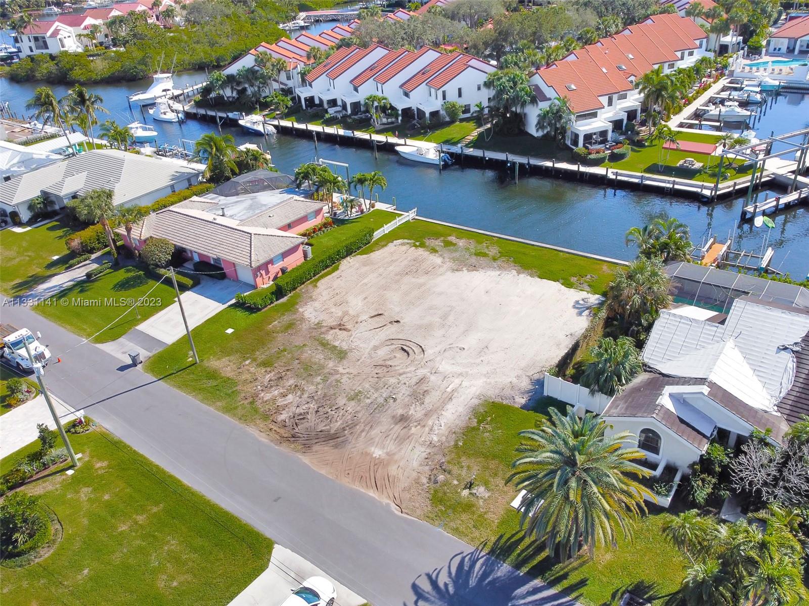 an aerial view of a house with a swimming pool and outdoor seating