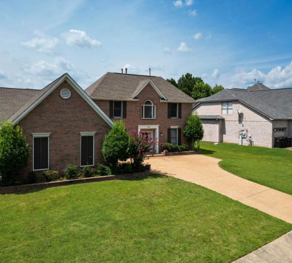 a front view of house with yard and green space