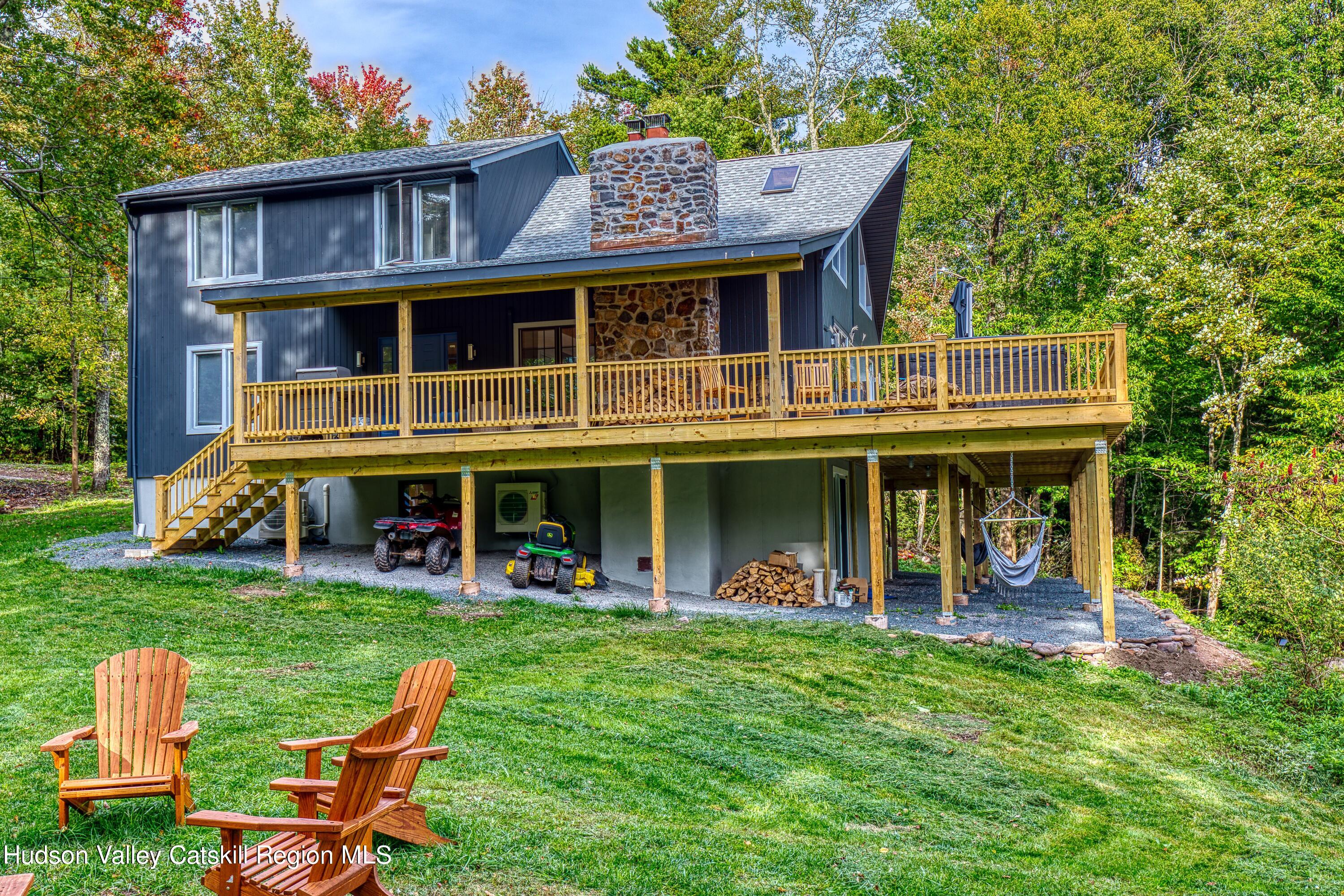 a view of an chairs and table tv and a fire pit