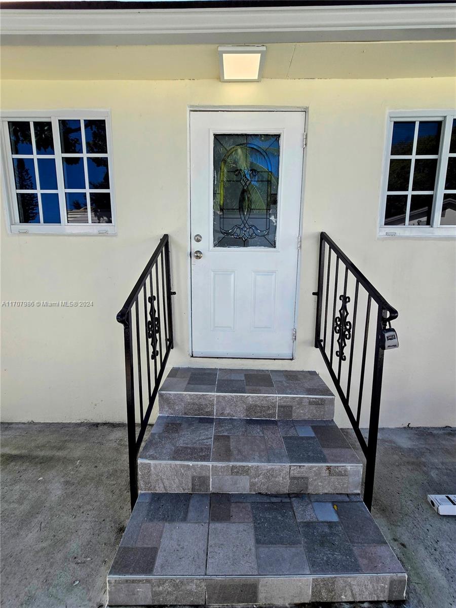 a view of staircase with wooden floor and a window