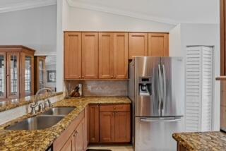 a kitchen with a refrigerator sink and cabinets