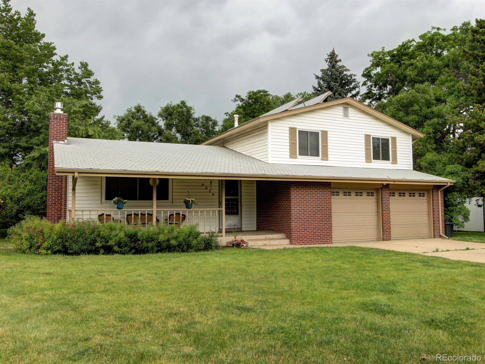 a front view of house with yard and green space