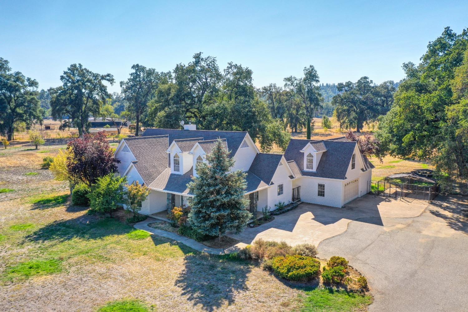 an aerial view of a house with yard swimming pool and outdoor seating