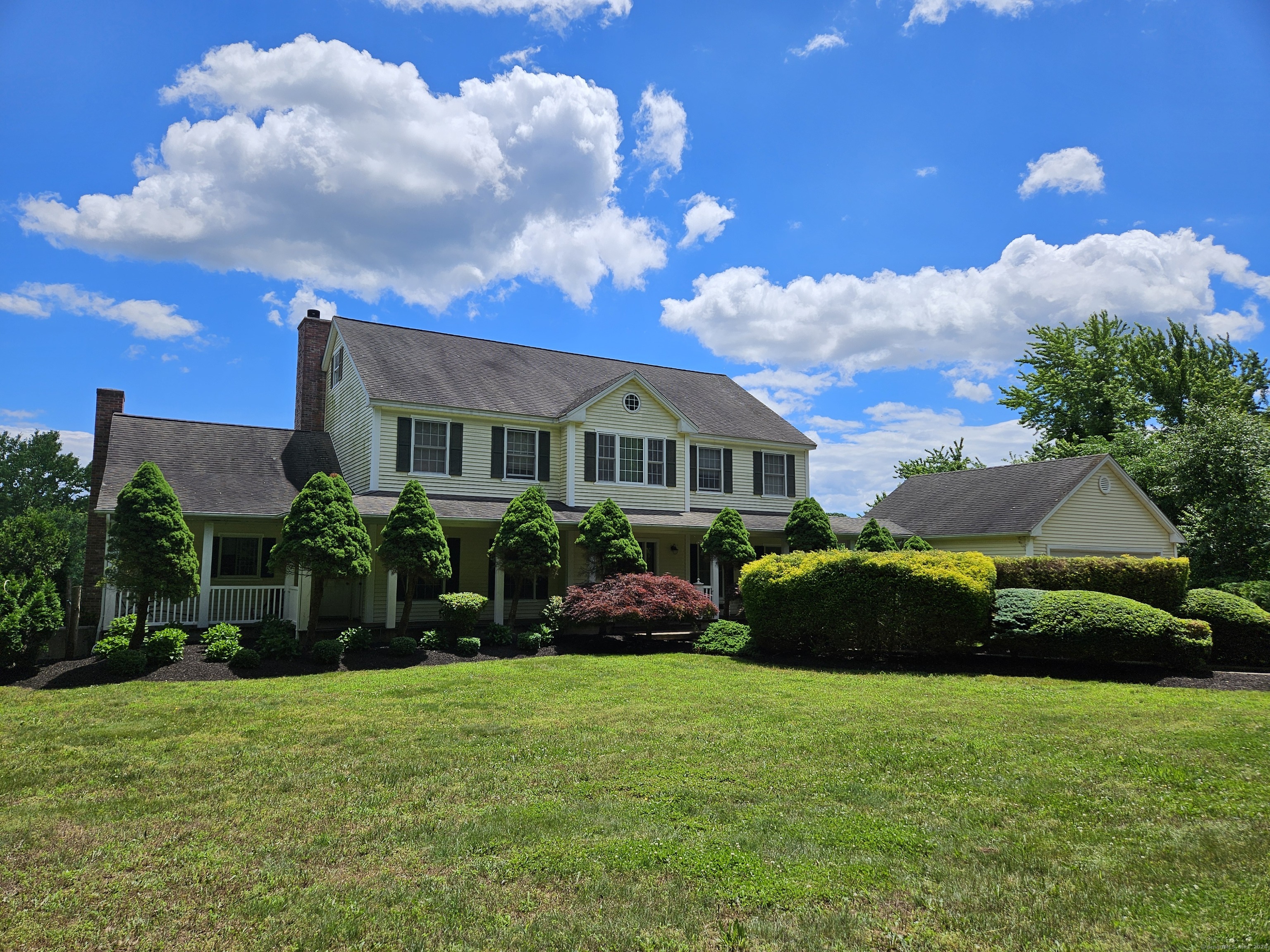 a front view of a house with a garden