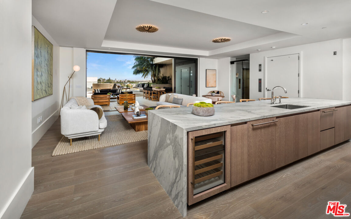 a view of kitchen island a sink and living room