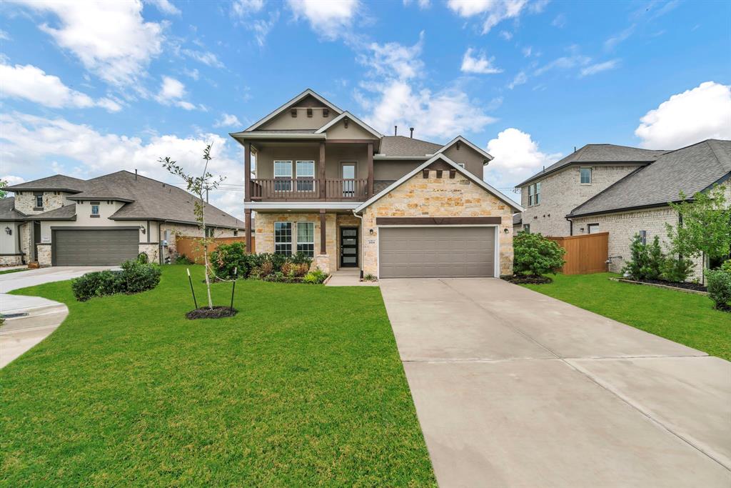 a front view of a house with a yard and trees