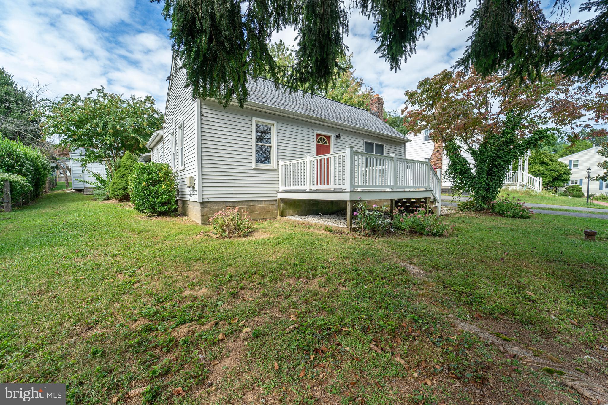 a view of a house with yard and a garden