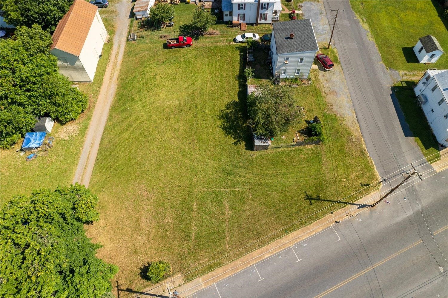 an aerial view of residential house with pool and garden