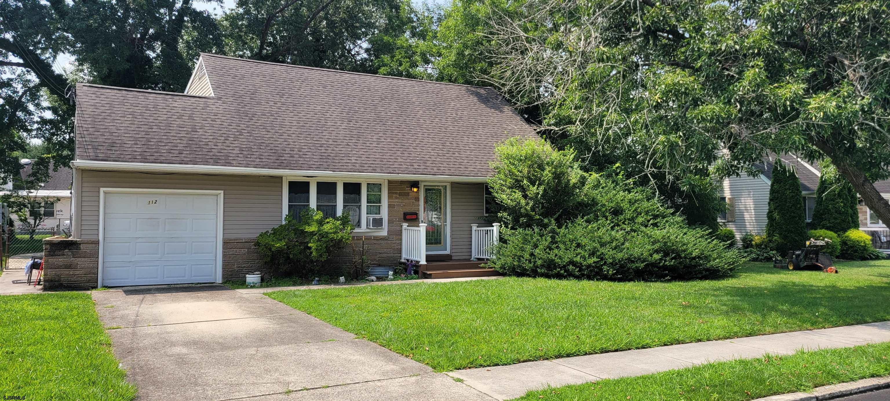 a view of a house with a yard and plants