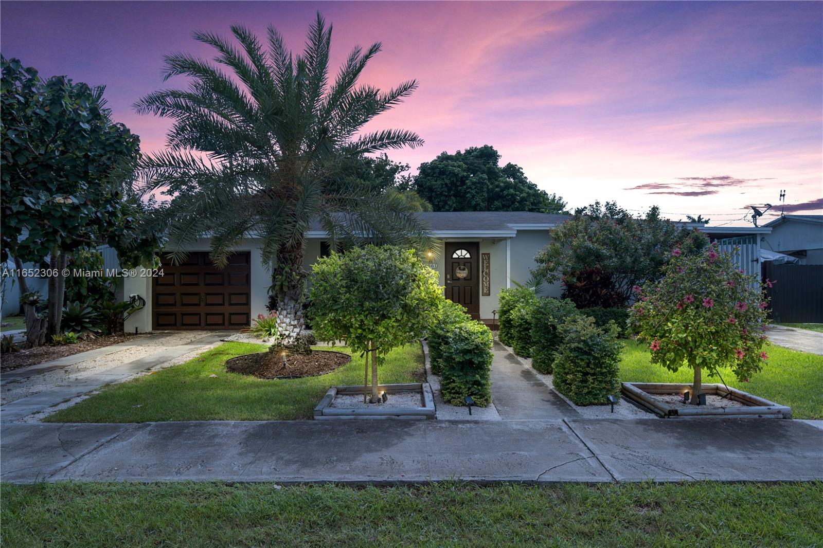 a front view of a house with a yard and a garage