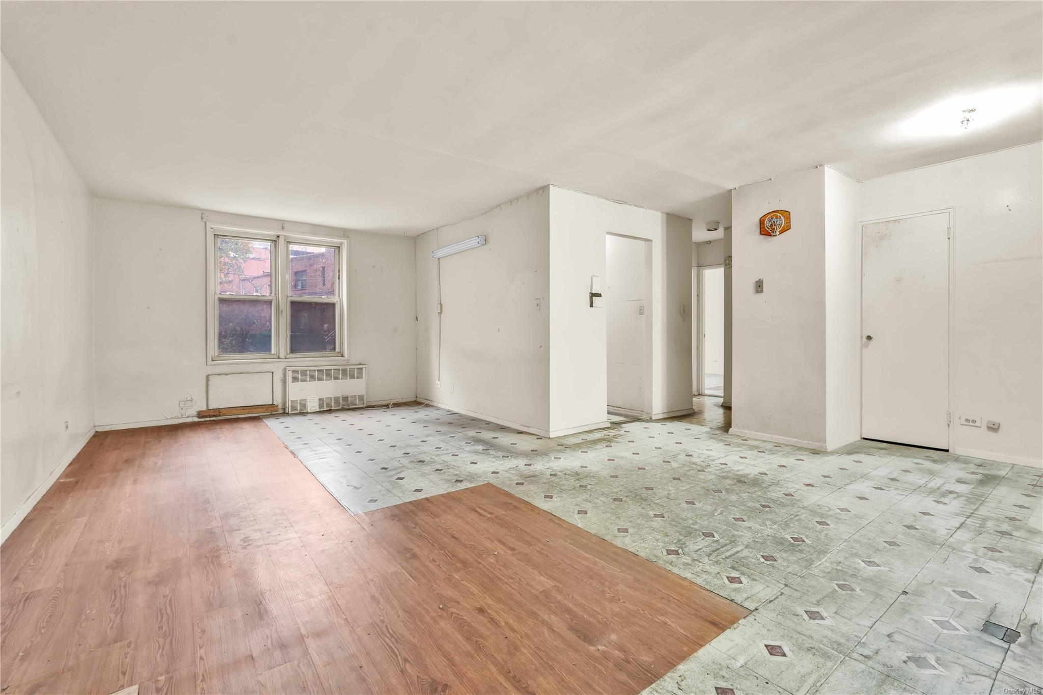 Spare room featuring radiator and light hardwood / wood-style flooring