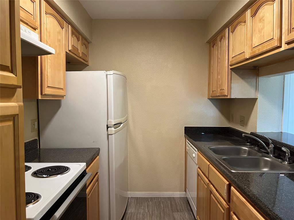 a kitchen with a sink a stove and a refrigerator