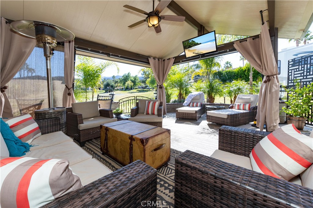 a living room with patio furniture and a floor to ceiling window