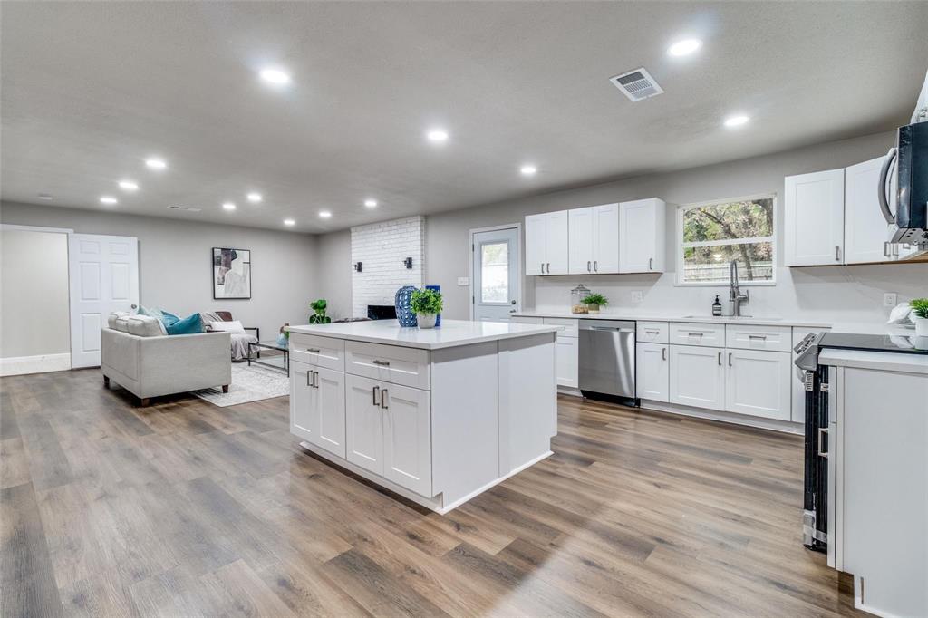 a kitchen with white cabinets and white stainless steel appliances