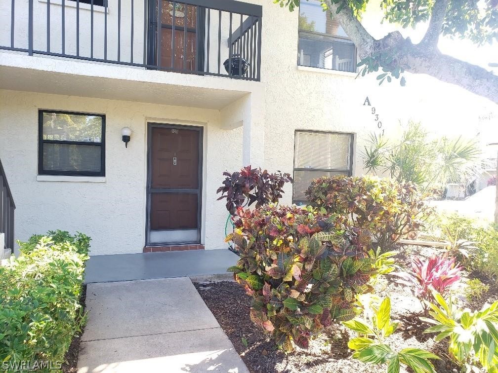 a front view of a house with lots of flowers