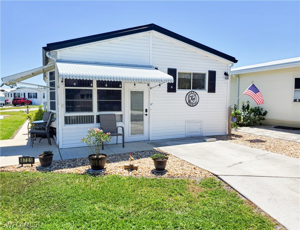 a front view of house with yard outdoor seating and barbeque oven